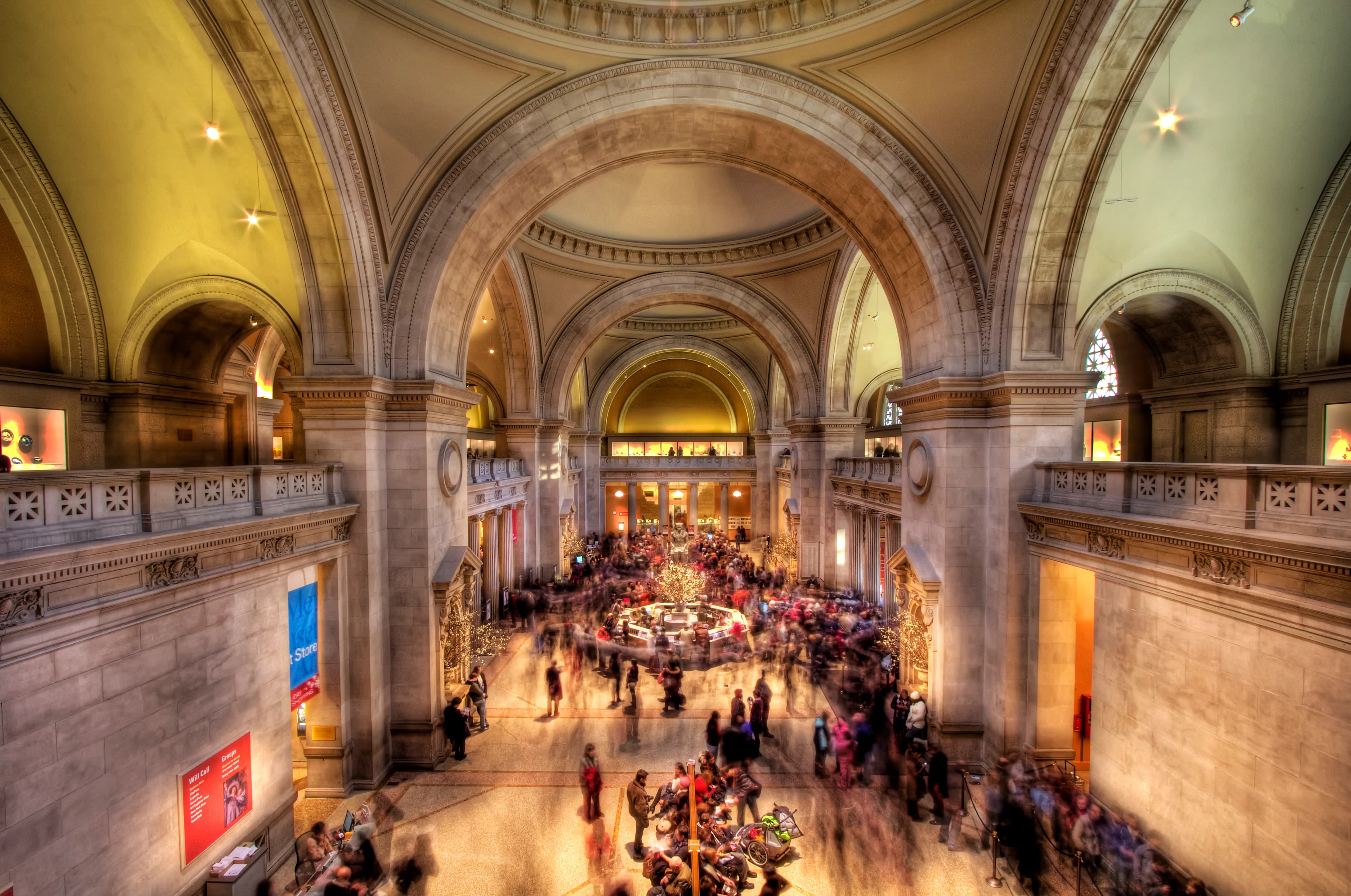 Classical museum interior with visitors viewing a grand exhibition
